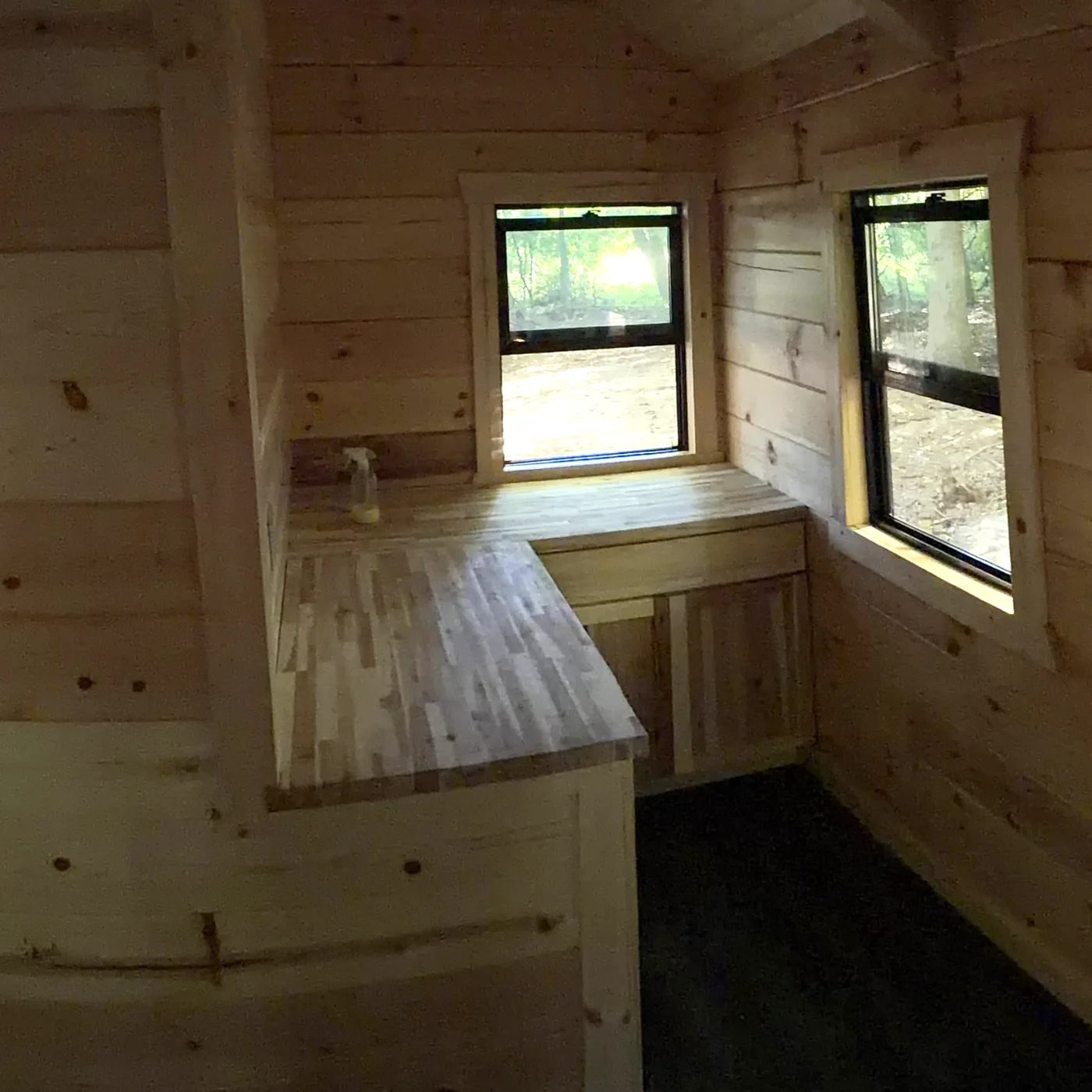 Orana cabin kitchen corner with butcher-block counter and knotty pine walls